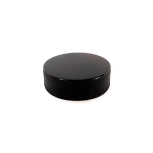 May include: A black hockey puck with a textured surface.