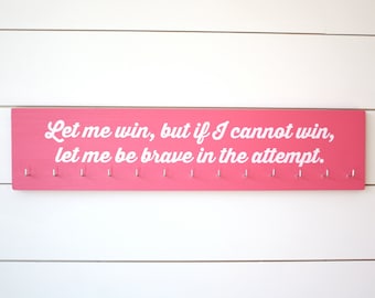 Titular de la medalla de olimpiadas especiales Déjame ganar, pero si no puedo ganar, déjame ser valiente en el intento. - Grande