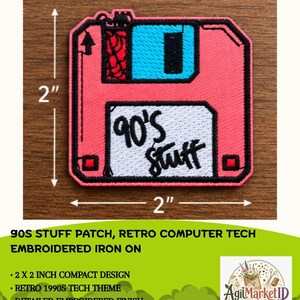 May include: A square embroidered patch shaped like a floppy disk, featuring a pink body, a bright blue sliding metal tab, and a white label area with the black text 90's Stuff. The patch measures 2 inches by 2 inches as indicated by arrows.