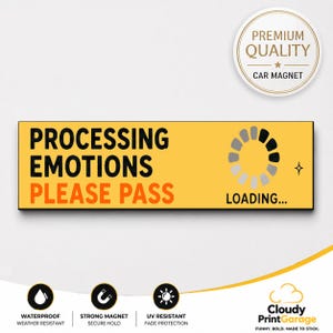 May include: A rectangular yellow car magnet featuring the black text "PROCESSING EMOTIONS" and orange text "PLEASE PASS" with a circular loading icon and the word "LOADING..." in black. A circular badge in the corner reads "PREMIUM QUALITY CAR MAGNET".
