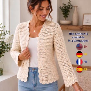 May include: A cream-colored, long-sleeved crochet cardigan featuring a scalloped edge along the front opening and cuffs. The text on the right side states: this pattern is available in 4 languages, followed by icons for the US, German, French, and Spanish flags.