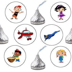 May include: A collection of Hershey's Kisses with custom stickers featuring cartoon characters and a blue jet. The stickers have images of a boy with a baton, a girl in a purple dress, a red spaceship, and a boy playing drums.