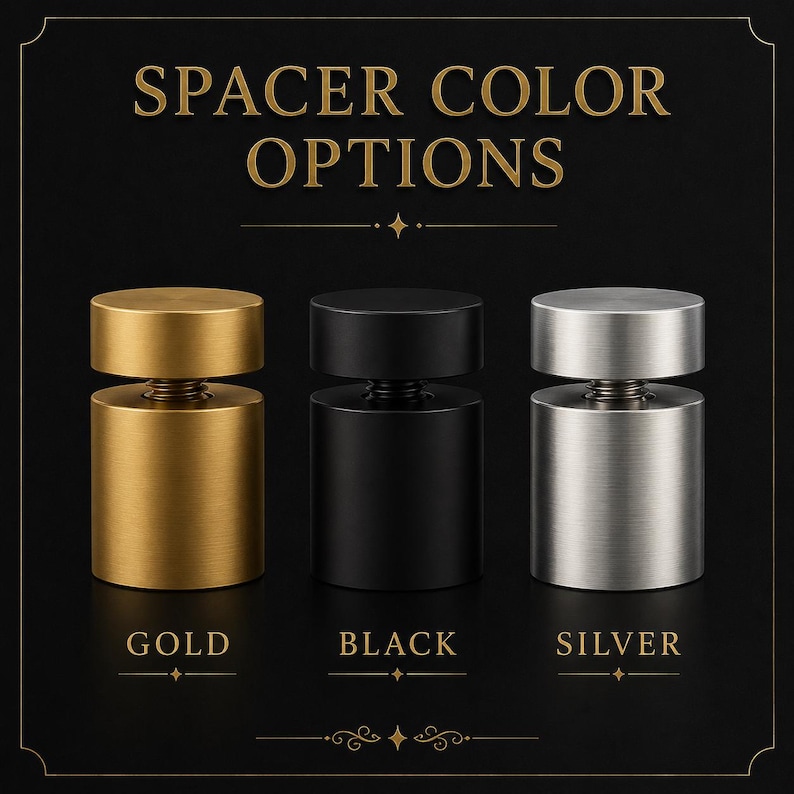 May include: Three cylindrical metal spacers displayed in a row with the text SPACER COLOR OPTIONS at the top. The spacers are available in gold, black, and silver finishes, each featuring a flat top cap and a threaded screw mechanism in the centre.