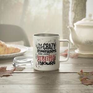 May include: A white mug with a handle and a clear lid featuring black and red text that reads: I'M NOT CRAZY MY PATIENTS ARE JUST DIFFERENT THAN YOURS. The design includes a distressed, textured ink effect surrounding the lettering on the mug.