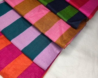 Tela ligera con estampado de rayas multicolor, cortada a medida para decoración del hogar.