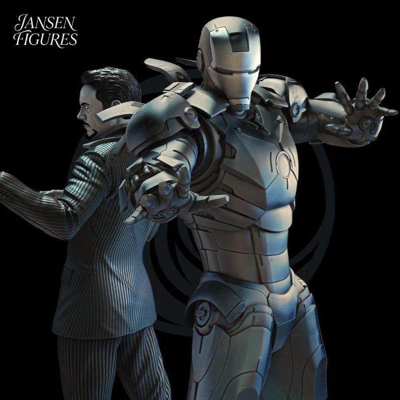 May include: A detailed sculpture of Iron Man in his silver armor, with a second figure in a suit behind him. The Jansen Figures logo is in the upper left corner. The figures are set against a black background.