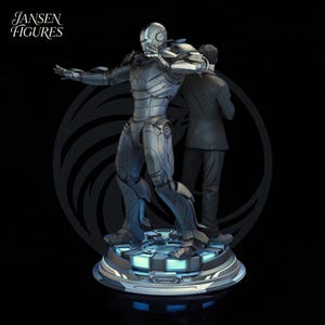 May include: A detailed statue featuring a silver robotic figure with outstretched arms, interacting with a man in a suit. The base is a circular platform with blue lighting. The Jansen Figures logo is in the upper left corner.