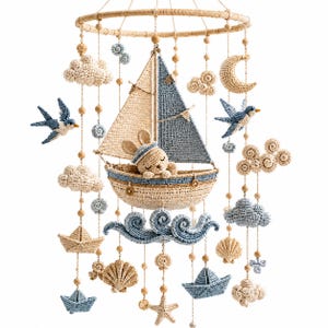 May include: A nautical-themed crochet mobile featuring a central sailboat with a sleeping rabbit figure, surrounded by hanging elements including blue and beige clouds, crescent moon, birds, seashells, starfish, and small paper-style boats.