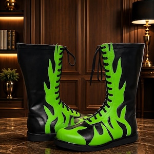May include: A pair of black and neon green boots with a flame design. The boots are lace-up and have a flat sole. The flame design is a bright neon green color and covers the front and sides of the boots.