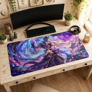May include: A rectangular desk mat featuring a vibrant digital illustration of a long-haired character with fox-like features, surrounded by swirling blue and purple energy, cherry blossoms, and a traditional building silhouette in the background.