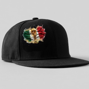 May include: A black baseball cap featuring a graphic on the front panel. The graphic displays a gold-colored trophy centered over a waving Italian flag with green, white, and red stripes, presented with a distressed, paint-splatter effect.