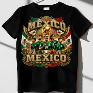 May include: A black t-shirt featuring a graphic print of five soccer players in green jerseys. The design includes the text MEXICO, EL TRI, and WORLD CUP 2026, along with golden eagles, a trophy, and the Mexican flag colors in a decorative frame.