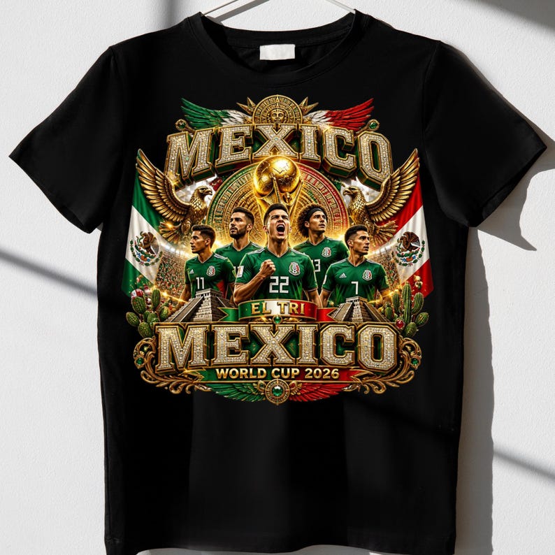 May include: A black t-shirt featuring a graphic print of five soccer players in green jerseys. The design includes the text MEXICO, EL TRI, and WORLD CUP 2026, along with golden eagles, a trophy, and the Mexican flag colors in a decorative frame.