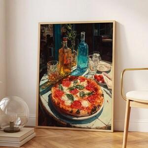 May include: A framed art print depicting a round pizza topped with red tomato slices and green basil leaves on a white plate. Beside the pizza are two glass bottles, one containing a golden liquid and the other a blue liquid, and two clear glasses.