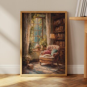 May include: A framed painting depicts a cozy reading nook. A tufted armchair with pillows sits near a window with sunlight streaming through. A bookshelf and a stack of books add to the inviting atmosphere. The artwork is in warm, earthy tones.
