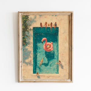 May include: A framed art print depicting an aerial view of a rectangular swimming pool with turquoise water. A large pink flamingo pool float sits in the center. Several figures are swimming or sitting on the edge of the pool deck.