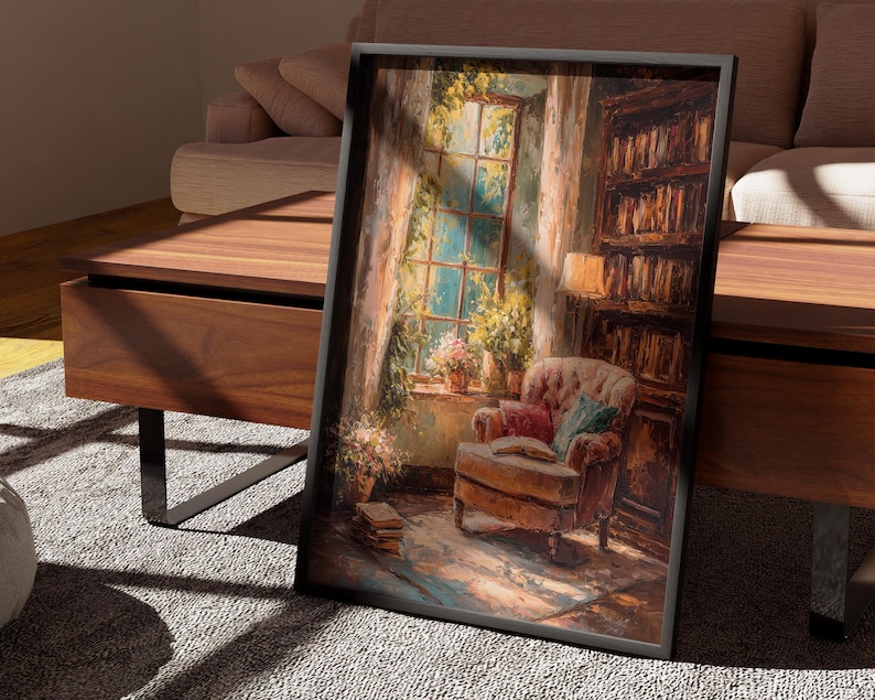 May include: A framed art print depicting a cozy reading nook. The artwork features a window with sunlight, an armchair, a bookshelf, and an open book. The color palette includes warm browns, greens, and blues, creating a relaxing atmosphere.