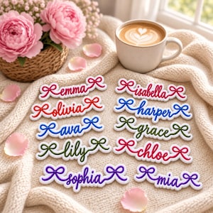May include: A collection of ten embroidered name patches, each featuring a cursive name flanked by two small bows. The names include Emma, Isabella, Olivia, Harper, Ava, Grace, Lily, Chloe, Sophia, and Mia, rendered in various colors on a white background.