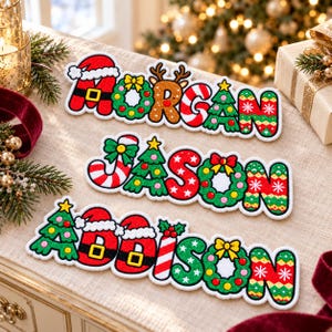 May include: Three embroidered name patches featuring the names MORGAN, JASON, and ADDISON. Each letter is decorated with Christmas-themed motifs including Santa hats, wreaths, reindeer antlers, candy canes, and Christmas trees in red, green, and gold.