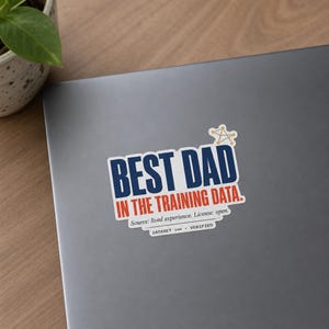 May include: A rectangular sticker with a white background featuring the dark blue text BEST DAD and orange text IN THE TRAINING DATA. Above the text is a small yellow network icon. Below is the text Source: lived experience. License: open. DATASET v00 • VERIFIED.