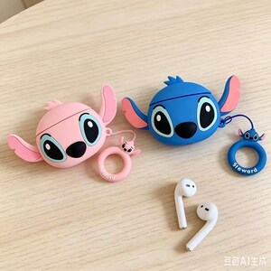 May include: Two silicone earphone cases shaped like cartoon characters, one in light pink and one in blue, each featuring large eyes and side ears. Both cases include a matching circular ring charm with a small character head and the text Steward.