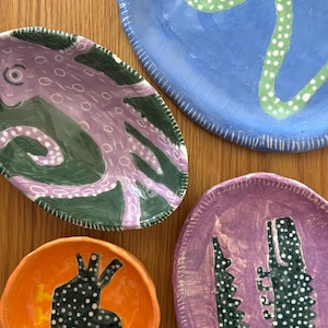 Small ceramic animal-shaped dishes, contemporary naive style.