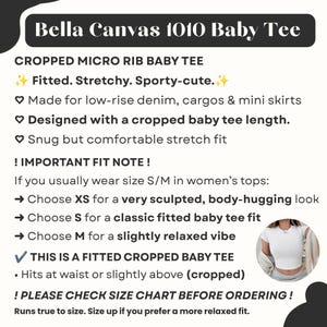 May include: White cropped baby tee from Bella Canvas 1010. The shirt is fitted, stretchy, and sporty-cute. The text on the image says it is designed with a cropped baby tee length and is made for low-rise denim, cargos & mini skirts.