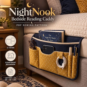 May include: A navy blue and mustard yellow fabric bedside reading caddy with multiple pockets, holding a book titled The Night We Watch the Stars, a smartphone, glasses, a charging cable, and pens. Text reads NightNook Bedside Reading Caddy.