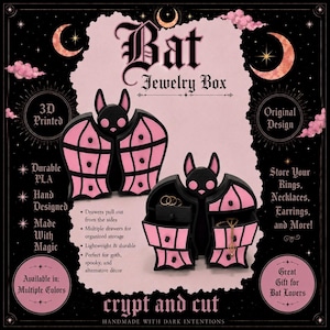 May include: A black and pink bat-shaped jewellery box with multiple pull-out drawers. The box features a stylised bat design with pink wing panels and black accents. Text on the image includes Bat Jewellery Box, 3D Printed, Original Design, and crypt and cut.