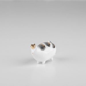 Porcelain white small cat figurine with gold/black decoration.