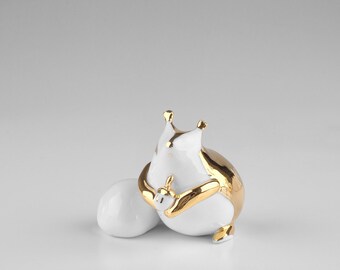 Porcelain  squirrel figurine with gold decoration.