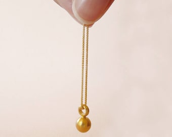 May include: A gold chain necklace with a small, round gold pendant.