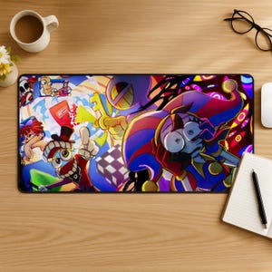 May include: A rectangular desk mat featuring a vibrant, multi-coloured digital illustration of various cartoon characters, including a jester in a red and blue hat, a character with a top hat, and abstract geometric shapes against a dark background.