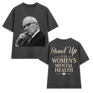 May include: A charcoal grey short-sleeve t-shirt featuring a black and white photographic print of a person in a suit and glasses on the front. The back displays the beige text Stand Up FOR WOMEN'S MENTAL HEALTH with a small heart icon below.