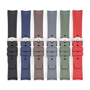 May include: Six watch straps in a range of colours: black, navy, brown, grey, olive green, and red. Each strap has a silver-coloured buckle. The straps are displayed against a white background.
