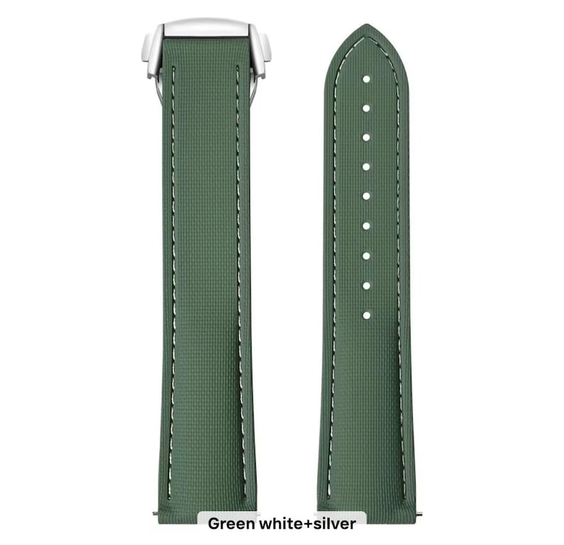 May include: A green watch strap with white stitching and a silver clasp. The strap is made of a textured material and has a classic design. The text "Green white+silver" is at the bottom of the image.