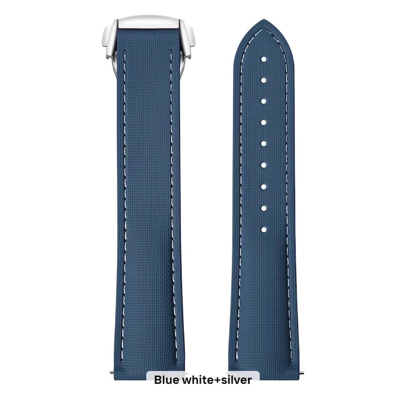 May include: Two-piece watch strap in a deep blue color with white stitching. The strap has a textured surface and a silver-colored clasp. The text "Blue white+silver" is at the bottom of the image.