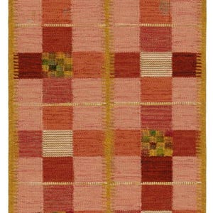 May include: A rectangular woven rug with a checkerboard pattern in shades of red, orange, and pink. The design includes squares of varying textures and colors, with accents of green and white. The rug has a yellow border.