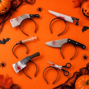 May include: Six black plastic headbands featuring Halloween-themed props: a meat cleaver, a serrated saw, a syringe, a kitchen knife, an axe, and a pair of scissors. Each prop is decorated with red paint splatters to resemble blood stains.