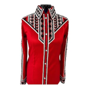 May include: A long-sleeved red shirt featuring a structured collar and a button-down front. The chest and sleeves are decorated with intricate geometric patterns in black, white, and silver, accented with numerous small clear crystals.