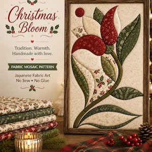 May include: A rectangular framed Kinusaiga fabric mosaic art piece titled Christmas Bloom, featuring a stylised flower design in red, cream, and green patterned fabrics. The artwork is displayed alongside stacks of folded holiday-themed fabric.
