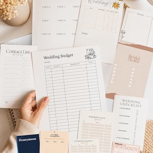 May include: A collection of wedding planning stationery, including a seating plan, budget tracker, checklist, and honeymoon itinerary. The pages are in neutral tones with minimalist designs, perfect for organizing wedding details.