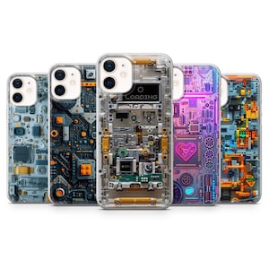 May include: Five clear smartphone cases featuring intricate electronic circuit board designs. The centre case displays a digital loading icon and the text LOADING. The designs include various colour schemes like blue, orange, and neon pink with a heart.