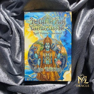 May include: A deck of cards featuring a colorful illustration of a deity with multiple arms, set against a backdrop of a globe. The text "Lord Vishnu Lenormand" and "Lite Edition" are visible. The deck is from the "MZ Oracle" brand.