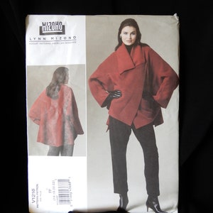 May include: A sewing pattern for a red wrap jacket with a large collar. The pattern is by Lynn Mizono, a Vogue Patterns American Designer. The pattern number is V1216.