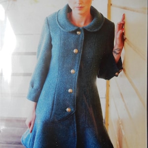 May include: Teal-colored coat with a rounded collar and gold buttons. The coat has a flared skirt and three-quarter sleeves. The coat is made of a textured fabric and has a classic, vintage style.