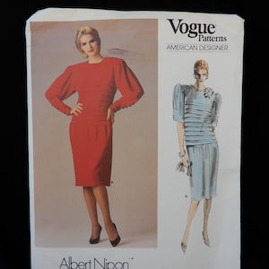 May include: Vogue Patterns American Designer Albert Nipon dress pattern, pattern number 1672. The pattern shows two women wearing a red dress and a blue and white striped dress.