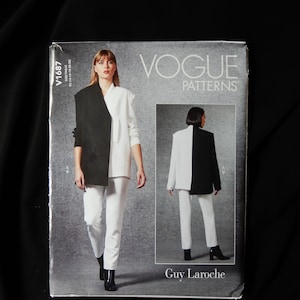 May include: Vogue Patterns sewing pattern featuring a two-tone blazer and trousers design. The pattern cover shows a woman wearing a black and white blazer and white trousers. The pattern is labelled V1687.