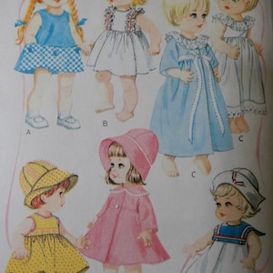 May include: Illustration of seven vintage doll outfits. The outfits include dresses, coats, hats, and a sailor-style ensemble. The color palette features blue, white, pink, and yellow, with various patterns and embellishments.