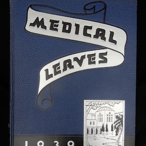 May include: A vintage book cover with the title "MEDICAL LEAVES" in bold, black letters on a silver banner. The cover is a textured, dark blue with the year "1939" at the bottom. A small, silver illustration of a building and trees is on the lower right.